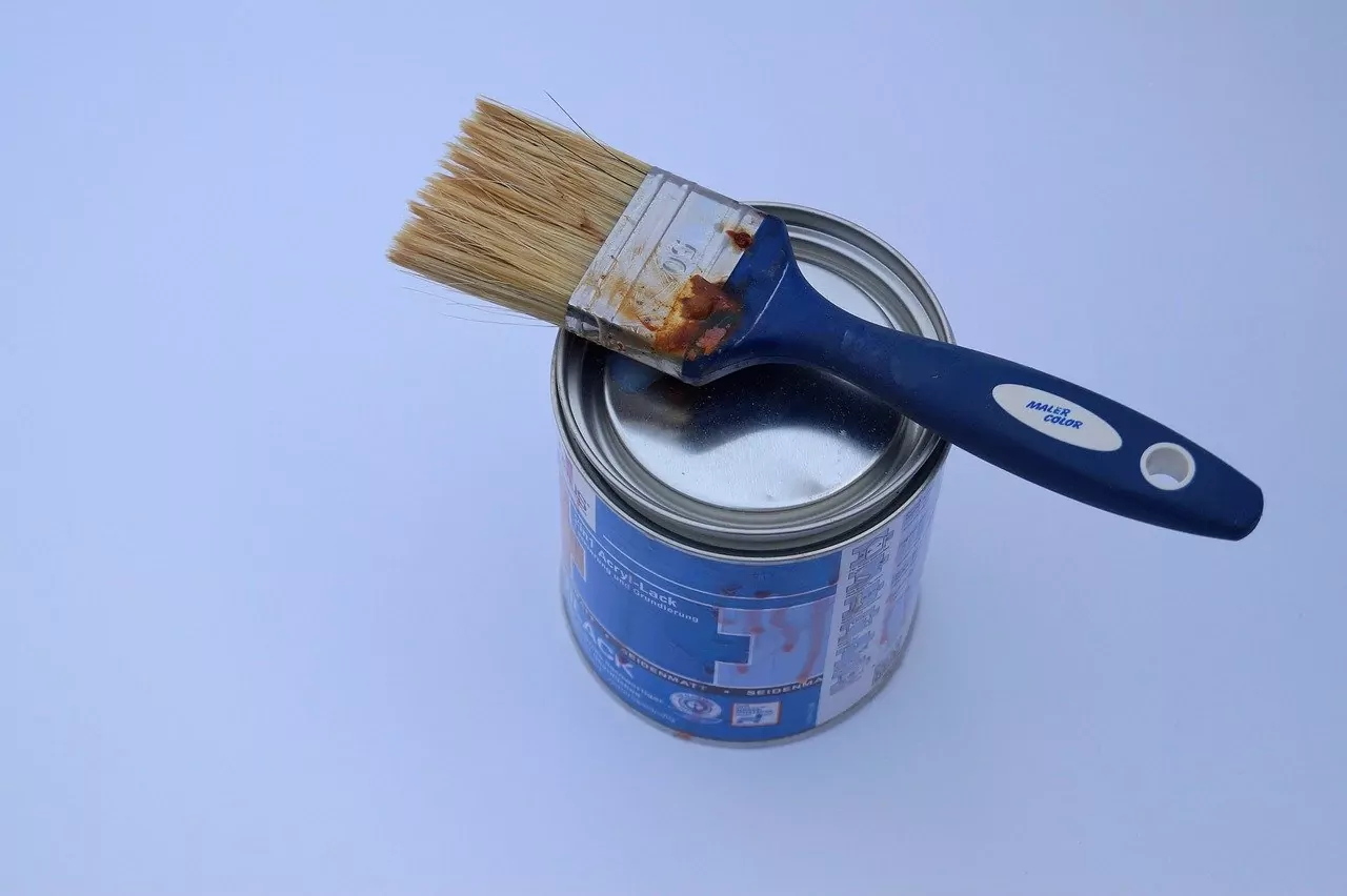 A blue paint box and a blue paint brush